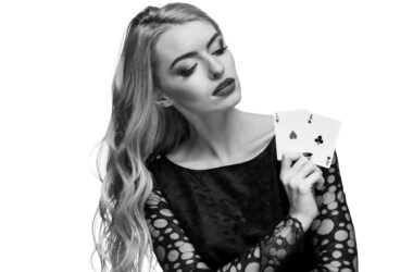 beautiful young woman holding two ace cards her hand isolated black background