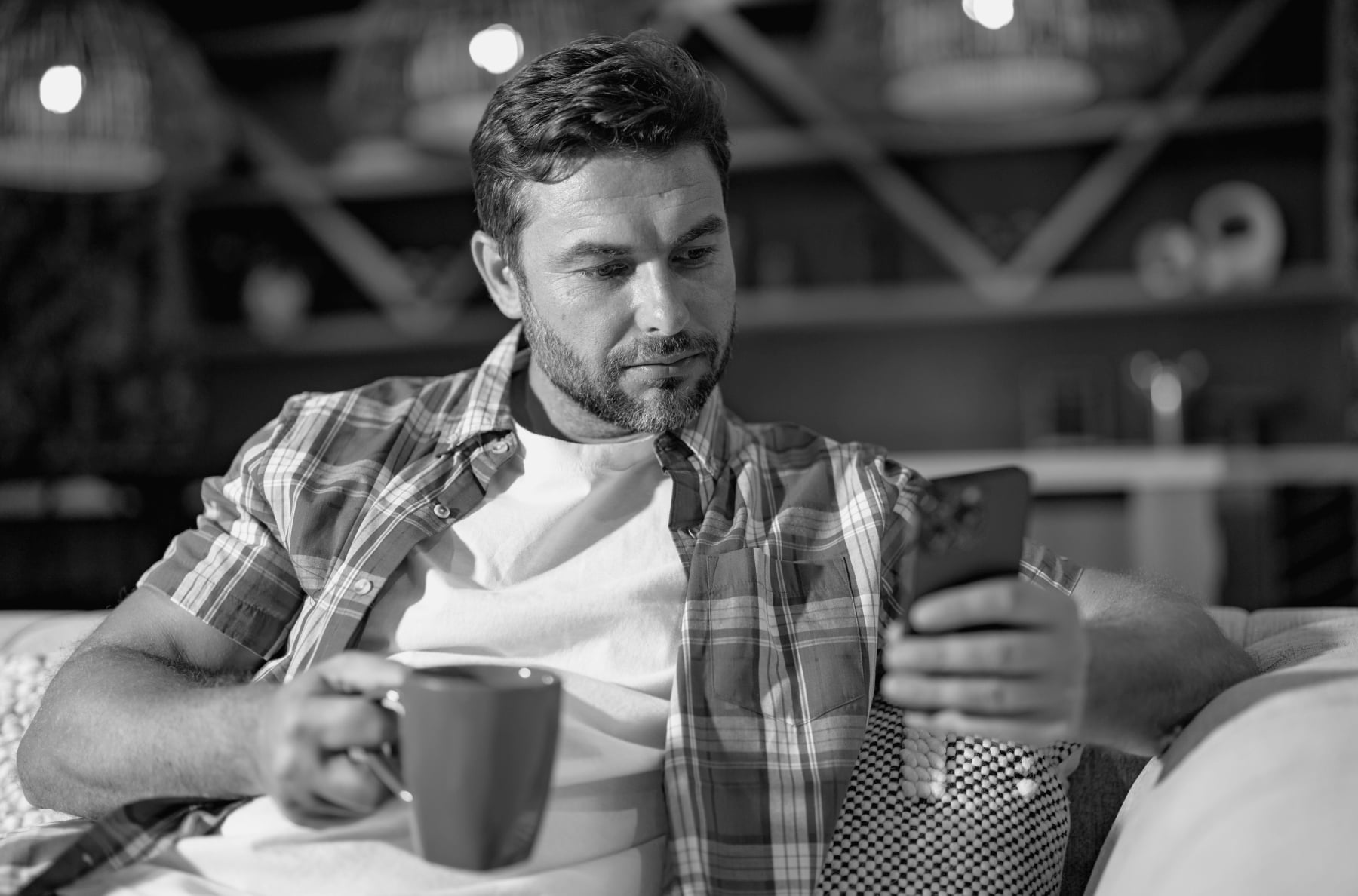 man relaxing sitting couch while looking mobile phone mature man using smartphone checking email home man reading news smartphone man talking mobile phone